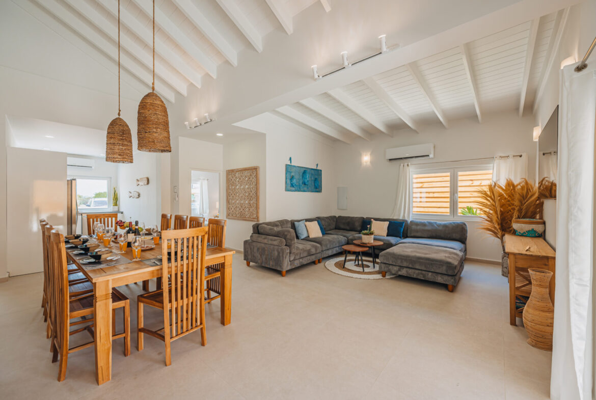 Open-plan living and dining area with vaulted ceiling and pendant lights, Seaside Modern Villa, Aruba