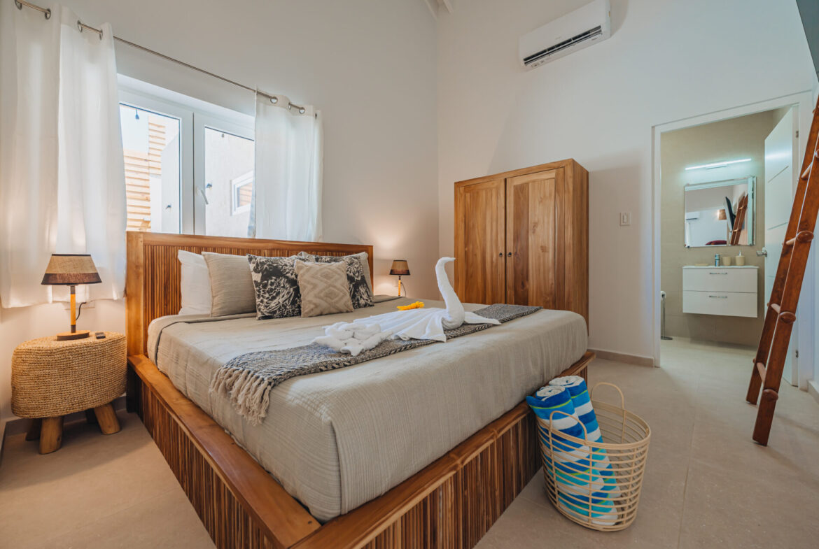 Bedroom with wardrobe and en-suite bathroom visible through open door, Seaside Modern Villa, Aruba
