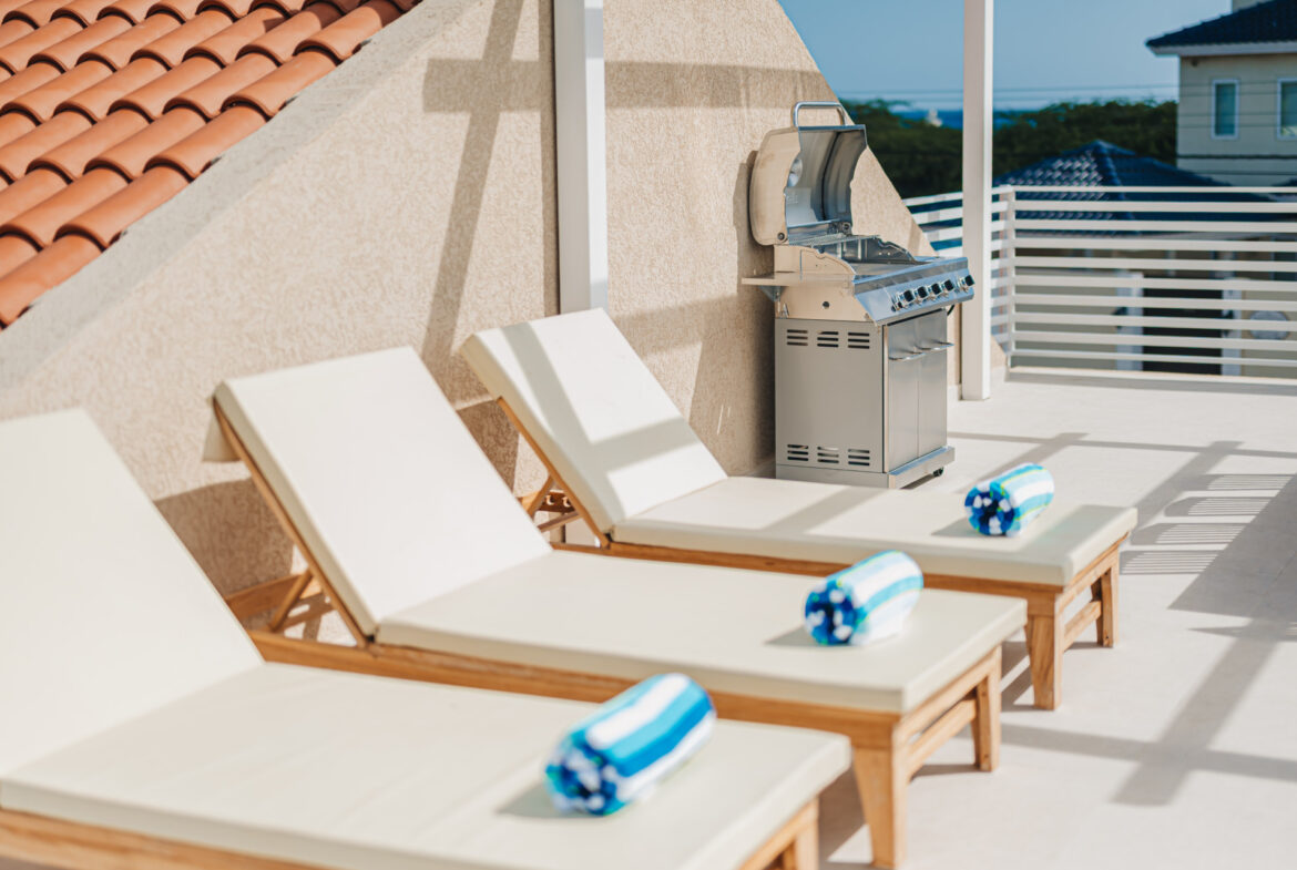 Rooftop lounge chairs with towels and ocean view, Seaside Modern Villa, Aruba
