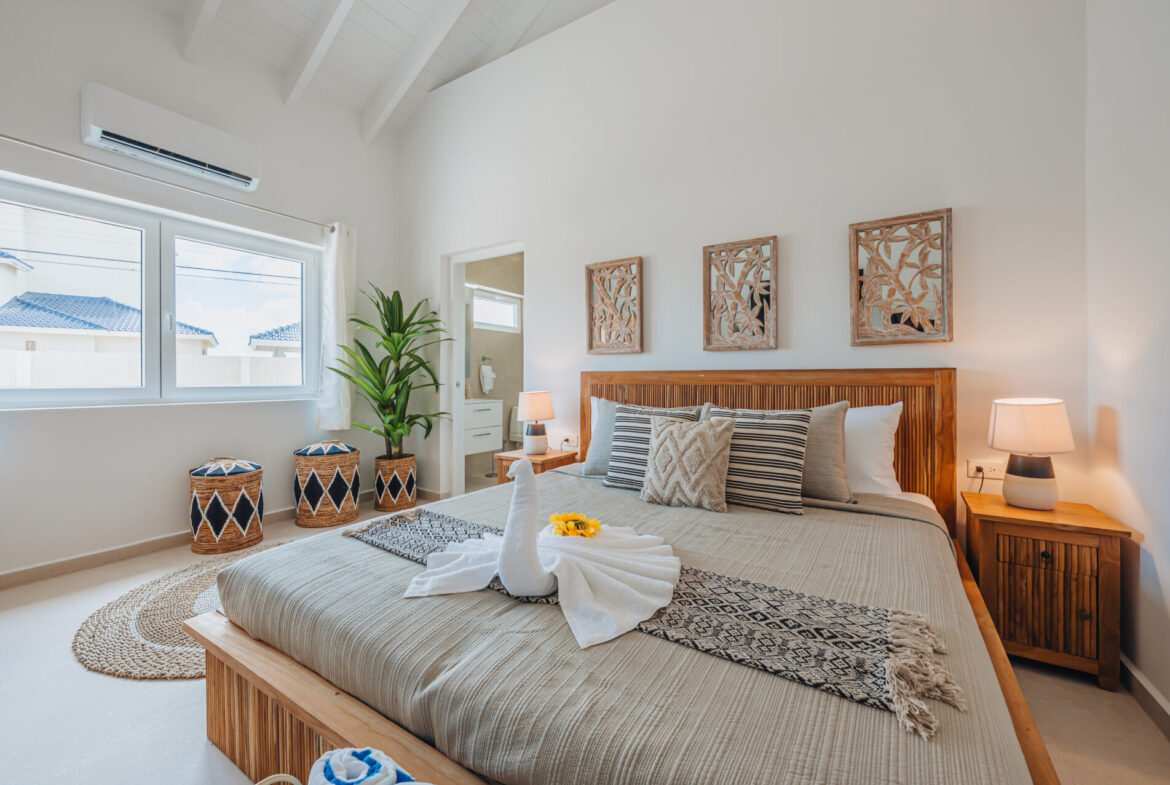 Bedroom with carved wood wall art panels above the bed, Seaside Modern Villa, Aruba