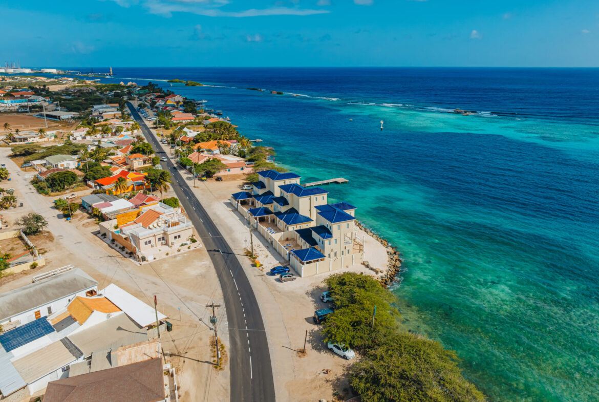 Aerial view of the blue-roofed villa row along the coastline, Aruba