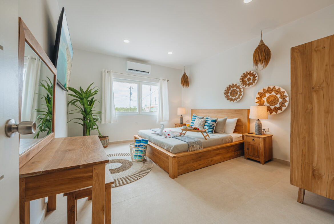 Bedroom with wall-mounted TV, desk, and woven wall decor, Seaside Modern Villa, Aruba