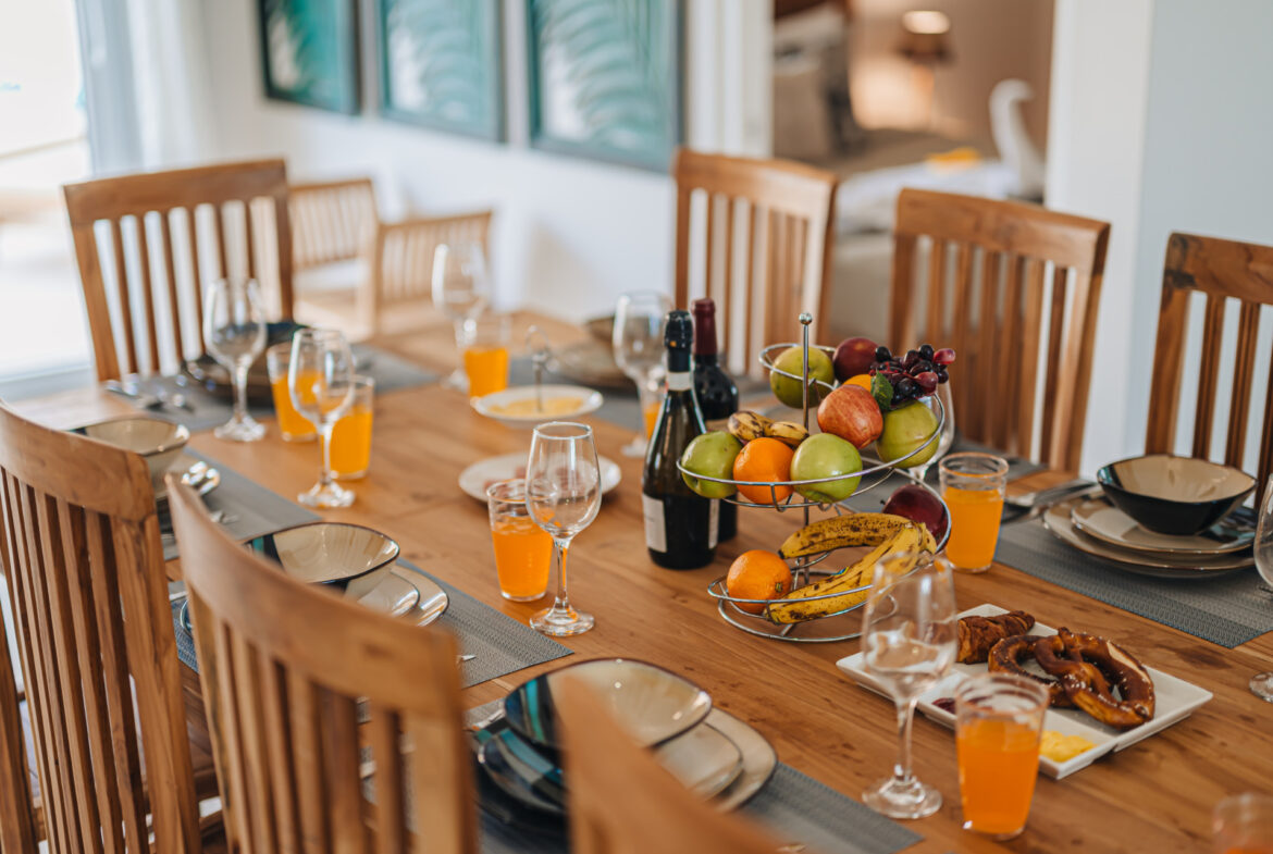 Dining table set with fresh fruit, juice, and bread for breakfast, Seaside Modern Villa, Aruba