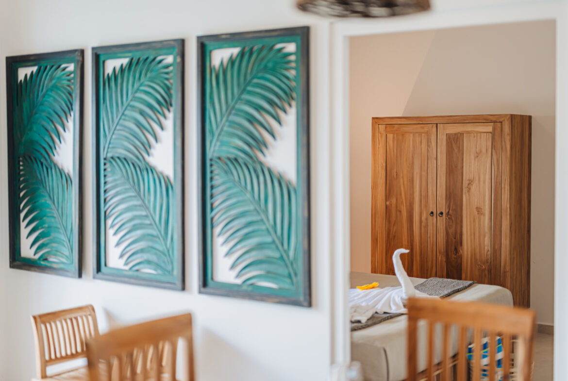 Bedroom with palm-leaf wall art panels and wood wardrobe, Seaside Modern Villa, Aruba